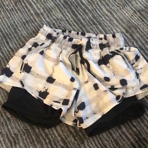 White, black and grey lululemon shorts with built in biker shorts underneath